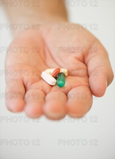 Hand holding pills.