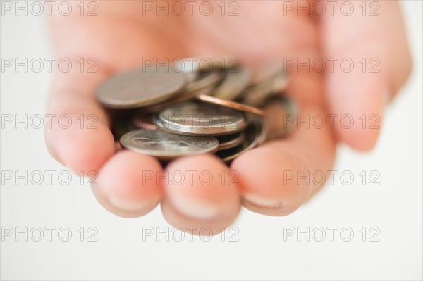 Hand holding coins.