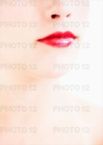 Studio shot of young woman wearing red lipstick.