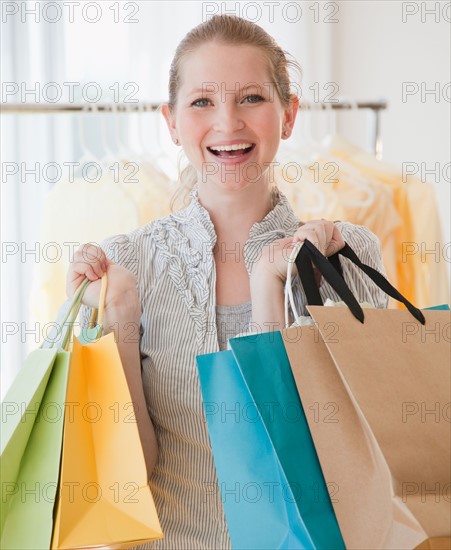 Young woman with shopping bags. Photo : Jamie Grill