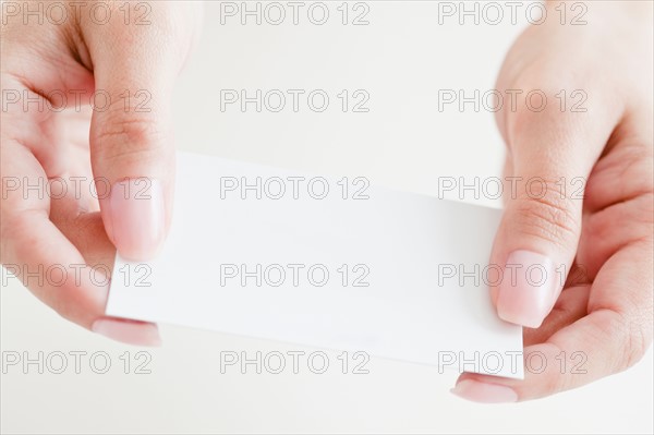 Close up of woman's hands holding credit card. Photo : Jamie Grill