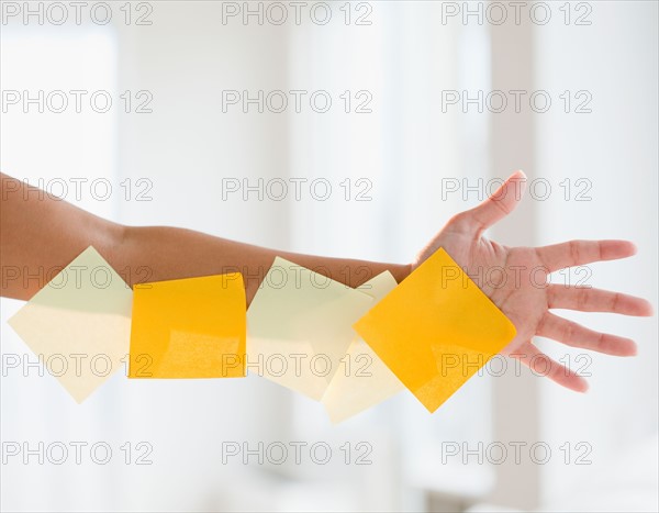 Close up of woman's hand with adhesive notes. Photo: Jamie Grill