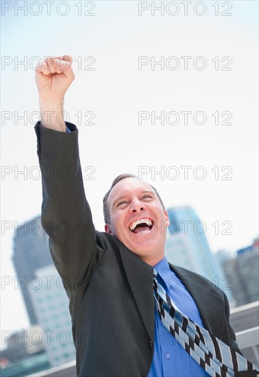 USA, New Jersey, Jersey City, Businessman gesturing with success. Photo : Jamie Grill