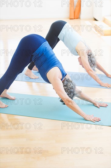 Two senior women practicing yoga. Photo : Daniel Grill