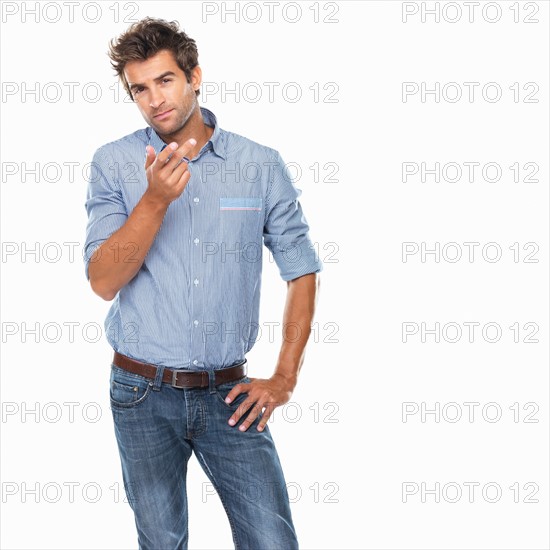 Studio shot of young thoughtful man gesturing. Photo : momentimages