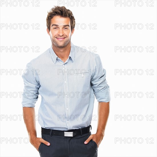 Portrait of confident business man standing with hands in pockets. Photo : momentimages