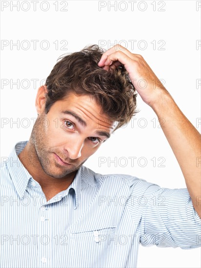 Portrait of handsome young executive scratching head. Photo : momentimages