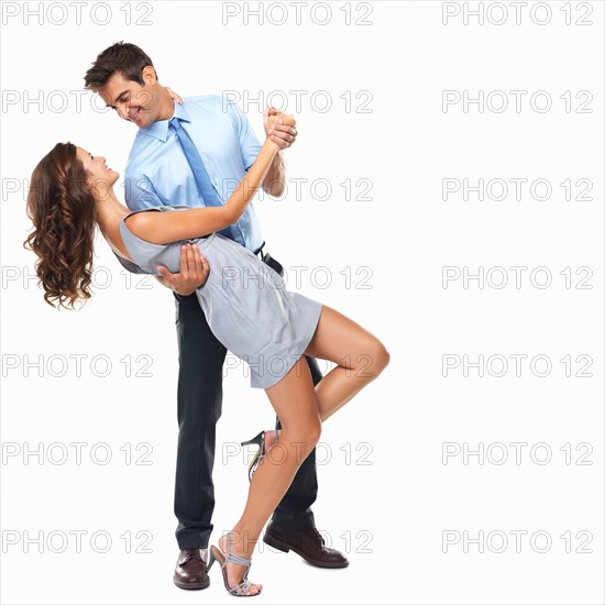 Studio shot of happy couple dancing. Photo: momentimages