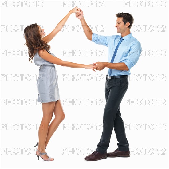 Studio shot of happy couple dancing. Photo: momentimages