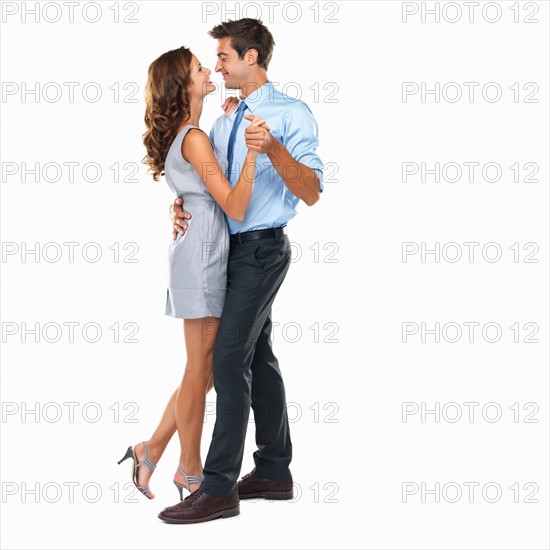 Studio shot of happy couple dancing. Photo: momentimages