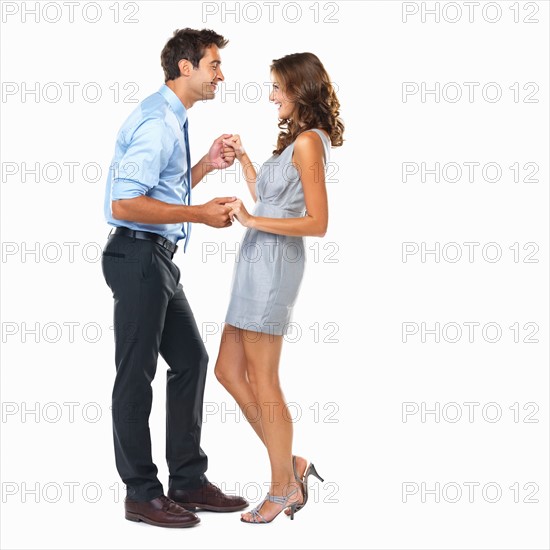 Studio shot of happy couple dancing. Photo : momentimages