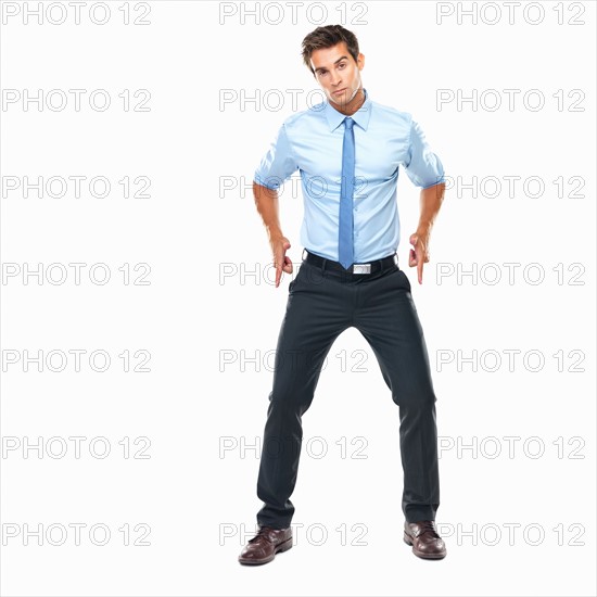 Studio shot of smart business man holding out gun shaped hands. Photo : momentimages