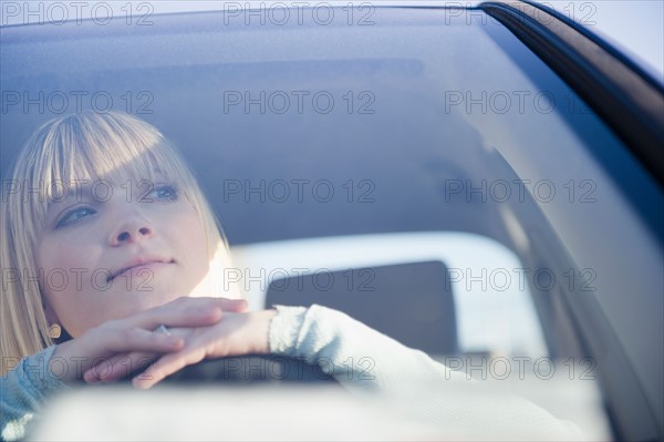 USA, Brooklyn, Williamsburg, Portrait of blonde woman driving car. Photo: Jamie Grill