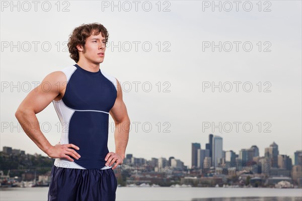 USA, Washington State, Seattle, Young athlete doing workout, skyline in background. Photo: Take A Pix Media