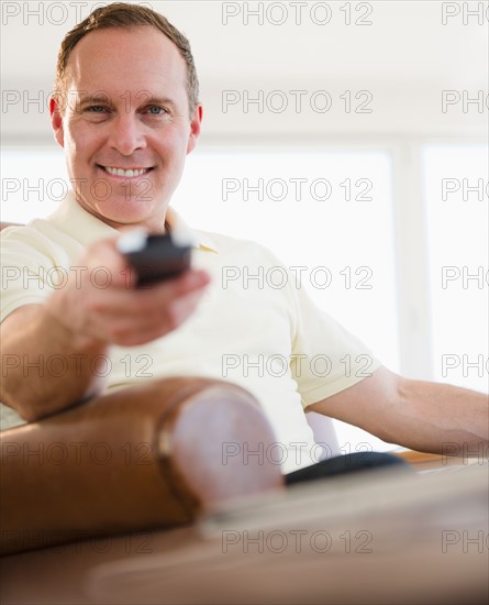 Man holding remote control. Photo : Jamie Grill