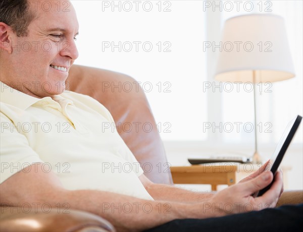 Man using digital tablet. Photo : Jamie Grill