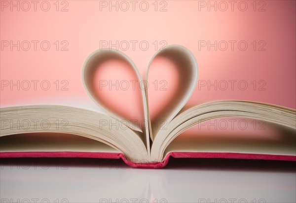 Close up of hear shape made of pages of open book. Photo : Jamie Grill