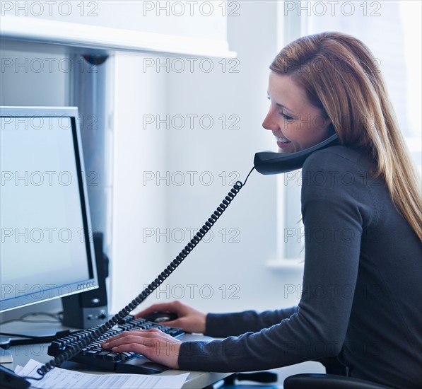 Young woman working in office. Photo: Daniel Grill