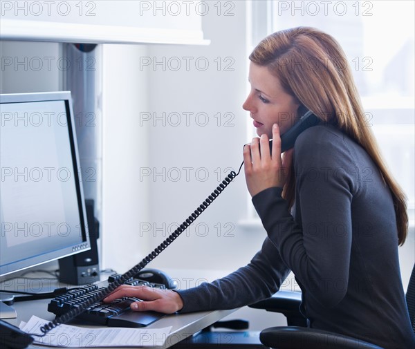 Young woman working in office. Photo: Daniel Grill