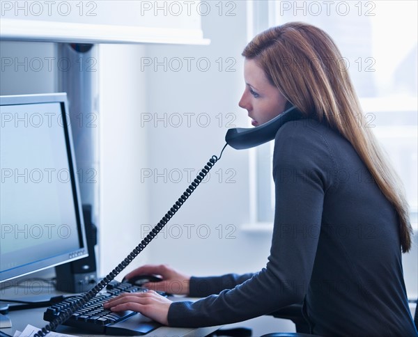 Young woman working in office. Photo: Daniel Grill