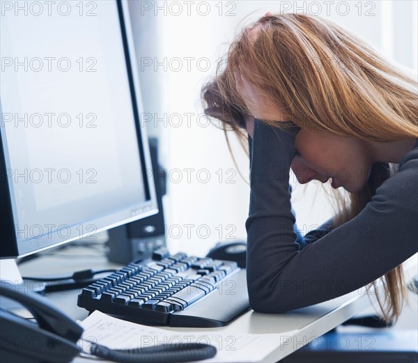 Young woman working in office. Photo: Daniel Grill