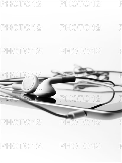 Studio shot of digital tablet and earphones. Photo : David Arky