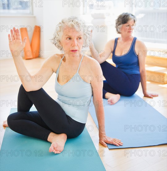 Two senior women practicing yoga. Photo : Daniel Grill