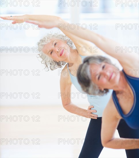 Two senior women stretching. Photo: Daniel Grill