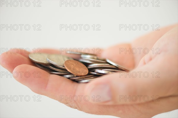 Hand holding coins.