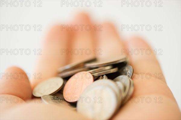 Hand holding coins.