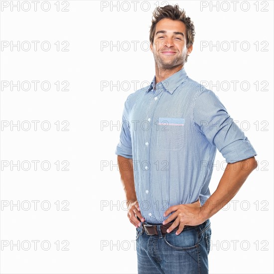 Studio shot of young pride man with hands on hips. Photo: momentimages