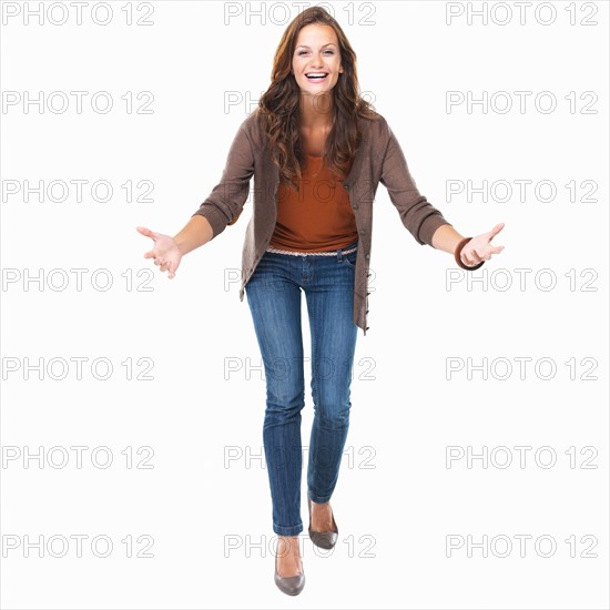 Studio shot of young enthusiastic woman smiling. Photo: momentimages