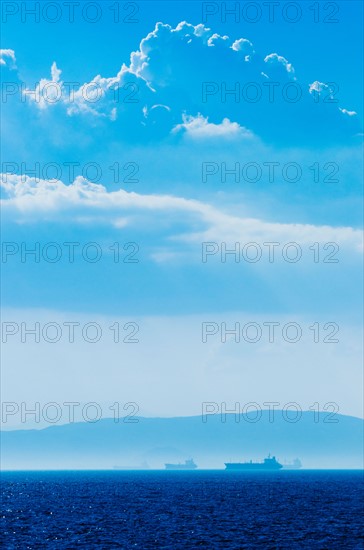 Greece, Oil tankers and cargo ships on Aegean Sea.