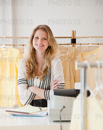 Young woman working in clothes shop. Photo: Jamie Grill