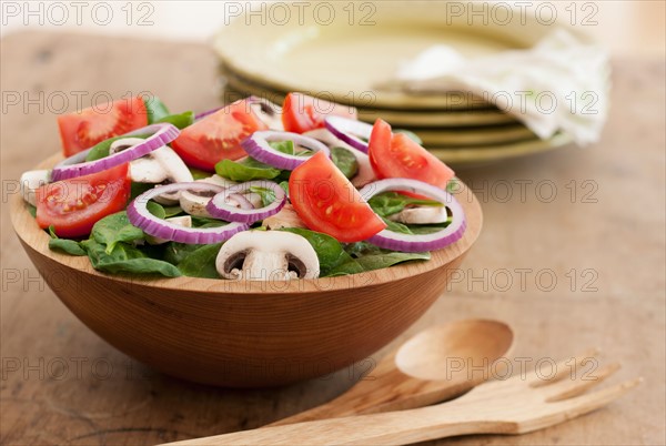 Fresh salad in bowl on table.