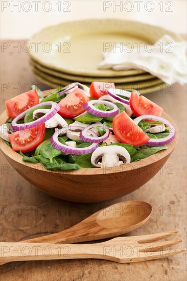 Fresh salad in bowl on table.