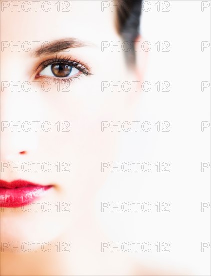Studio portrait of young woman with red lips.