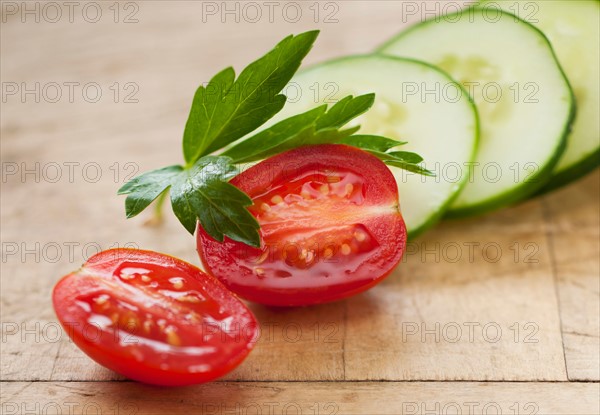 Fresh tomatoes and cucumber with herb.