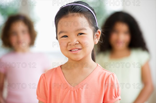 Portrait of girl (6-7) with friends.