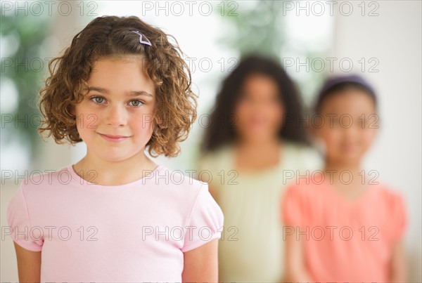 Portrait of girl (6-7) with friends.