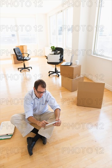 Businessman using tablet in new office.