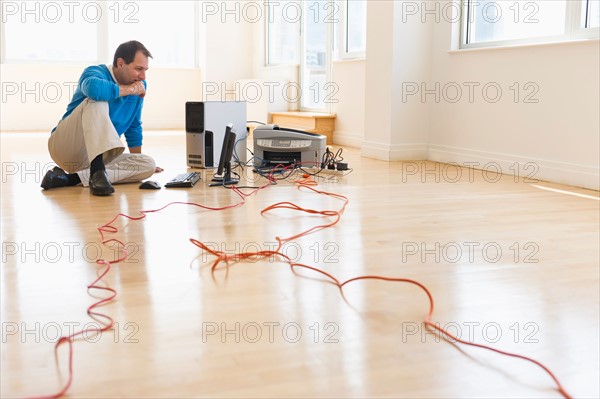 Businessman setting up internet in new office.