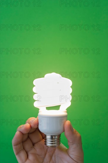 Hand holding lightbulb.