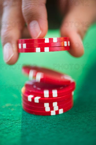 Hand handling gambling chips.