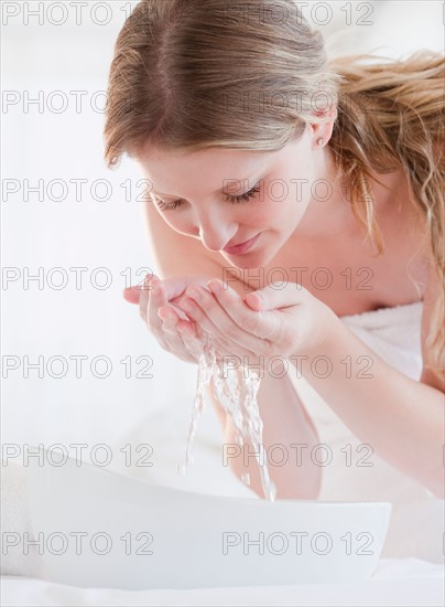 Young woman washing face. Photo: Jamie Grill