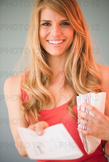 Portrait of blonde woman showing tickets. Photo: Jamie Grill