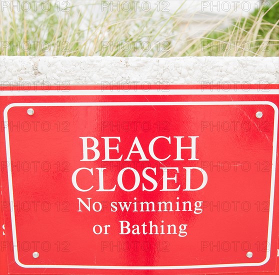 USA, New York, Queens, Rockaway Beach, close up of warning sign about closed beach. Photo: Jamie Grill
