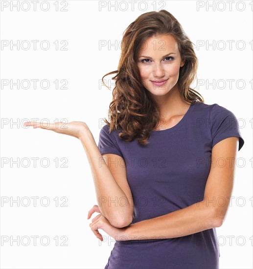 Studio portrait of attractive young woman gesturing and smiling. Photo: momentimages