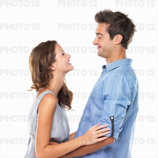 Couple in love looking at each other and smiling. Photo: momentimages