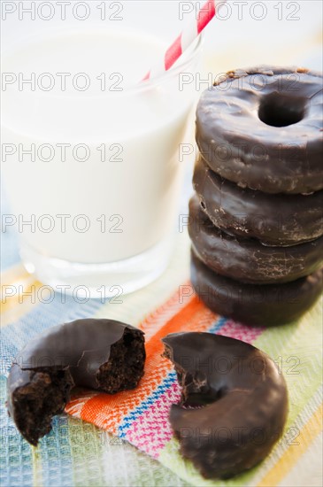 Close up of chocolate donuts and milk. Photo : Jamie Grill